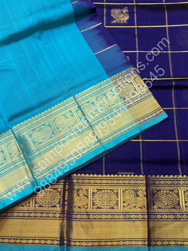 Indigo Blue with Turquoise Blue , Rich Mayil and Chakram butta in the body with Zari Checks , Traditional borders and Rich Pallu Pure Silk Cotton Saree