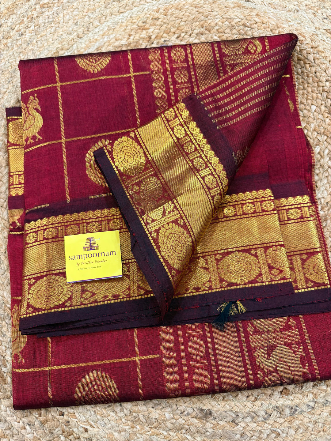 Maroon , Zari Kattam in the body with mayil and Chakram butta , traditional borders and rich Pallu , silk cotton saree