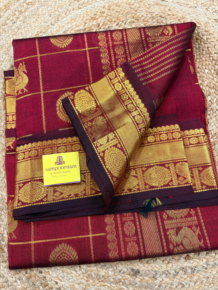 Maroon , Zari Kattam in the body with mayil and Chakram butta , traditional borders and rich Pallu , silk cotton saree