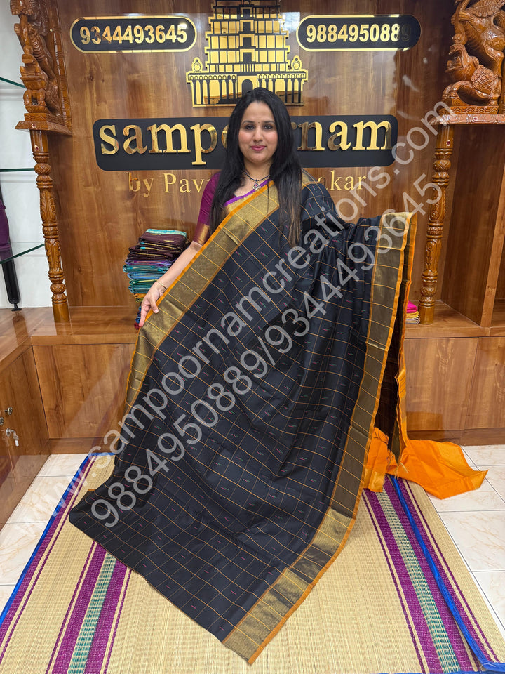 Black with Orange , checks in the body and rain drop thread butta in the body and Pallu Semi Silk Cotton Saree