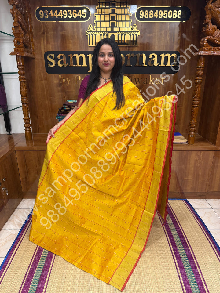 Yellow with Pink , checks in the body and rain drop thread butta in the body and Pallu Semi Silk Cotton Saree