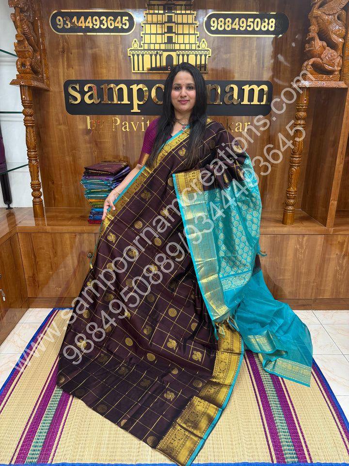 Cofee Brown with Turquoise Blue , Rich Mayil and Chakram butta in the body with Zari Checks , Traditional borders and Rich Pallu Pure Silk Cotton Saree