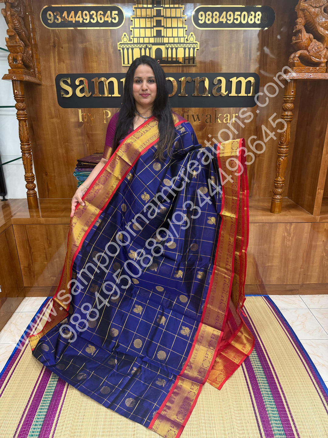 Dark Blue with Red , Rich Mayil and Chakram butta in the body with Zari Checks , Traditional borders and Rich Pallu Pure Silk Cotton Saree