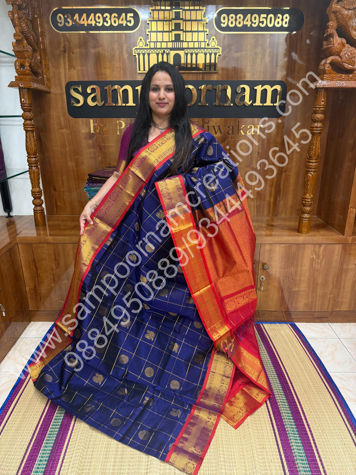 Dark Blue with Red , Rich Mayil and Chakram butta in the body with Zari Checks , Traditional borders and Rich Pallu Pure Silk Cotton Saree