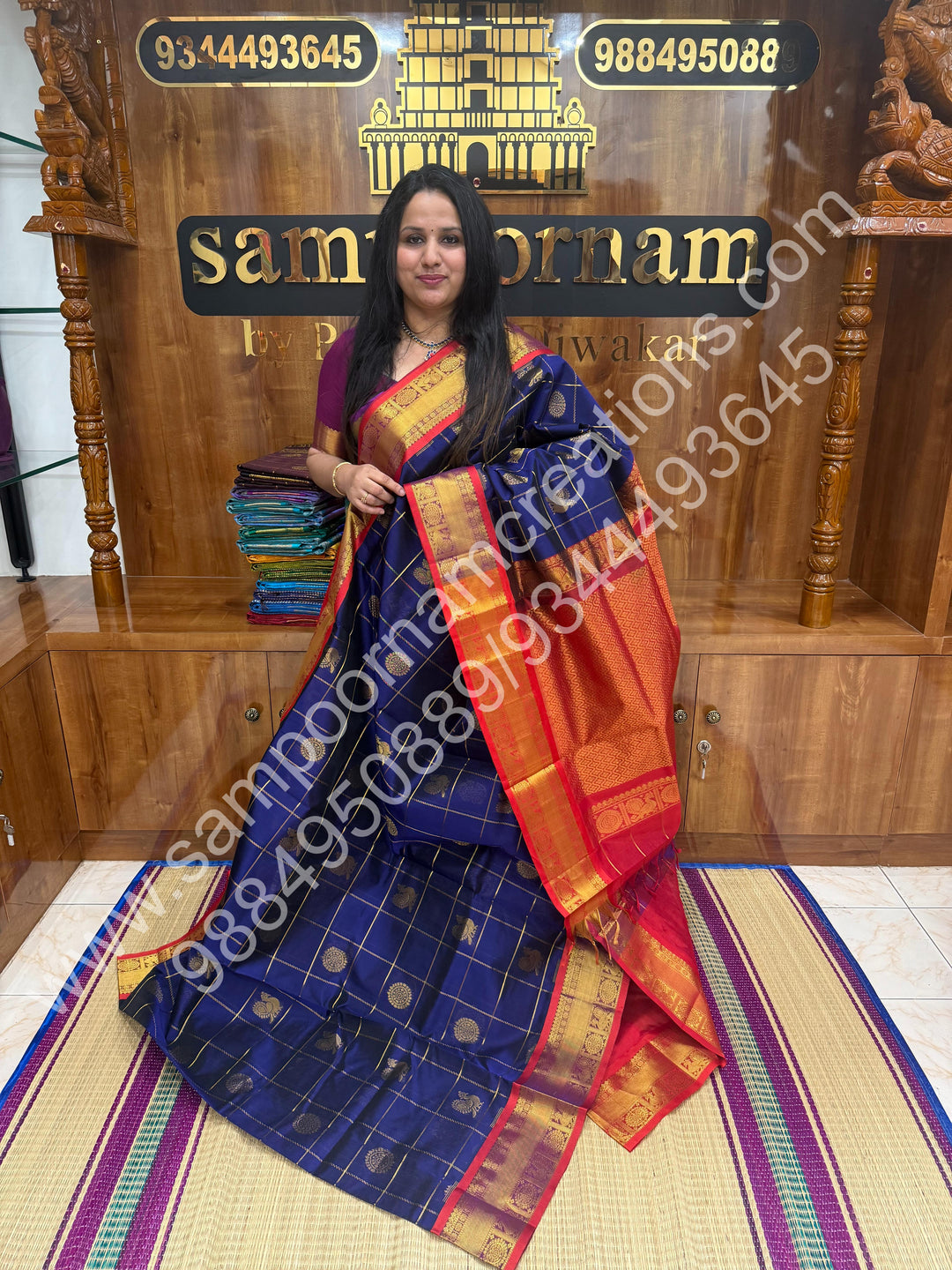 Dark Blue with Red , Rich Mayil and Chakram butta in the body with Zari Checks , Traditional borders and Rich Pallu Pure Silk Cotton Saree