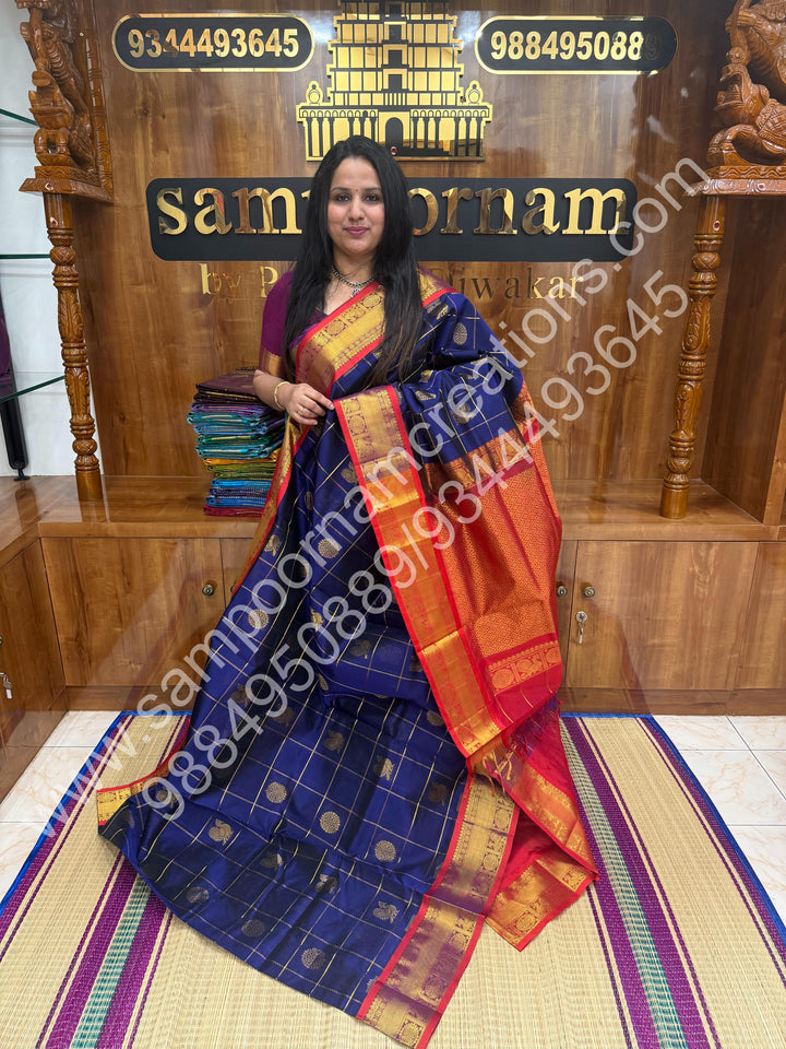 Dark Blue with Red , Rich Mayil and Chakram butta in the body with Zari Checks , Traditional borders and Rich Pallu Pure Silk Cotton Saree