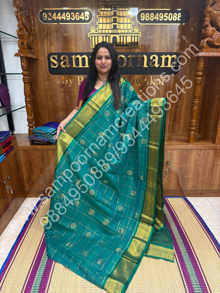 Rexona Green , Rich Mayil and Chakram butta in the body with Zari Checks , Traditional borders and Rich Pallu Pure Silk Cotton Saree