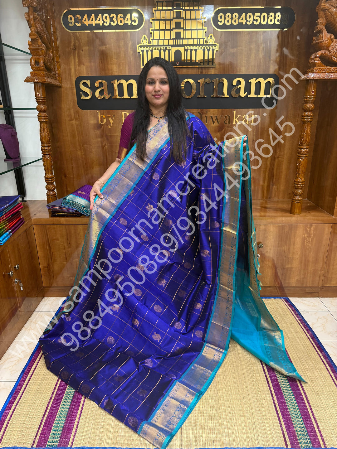 Indigo Blue with Turquoise Blue , Rich Mayil and Chakram butta in the body with Zari Checks , Traditional borders and Rich Pallu Pure Silk Cotton Saree