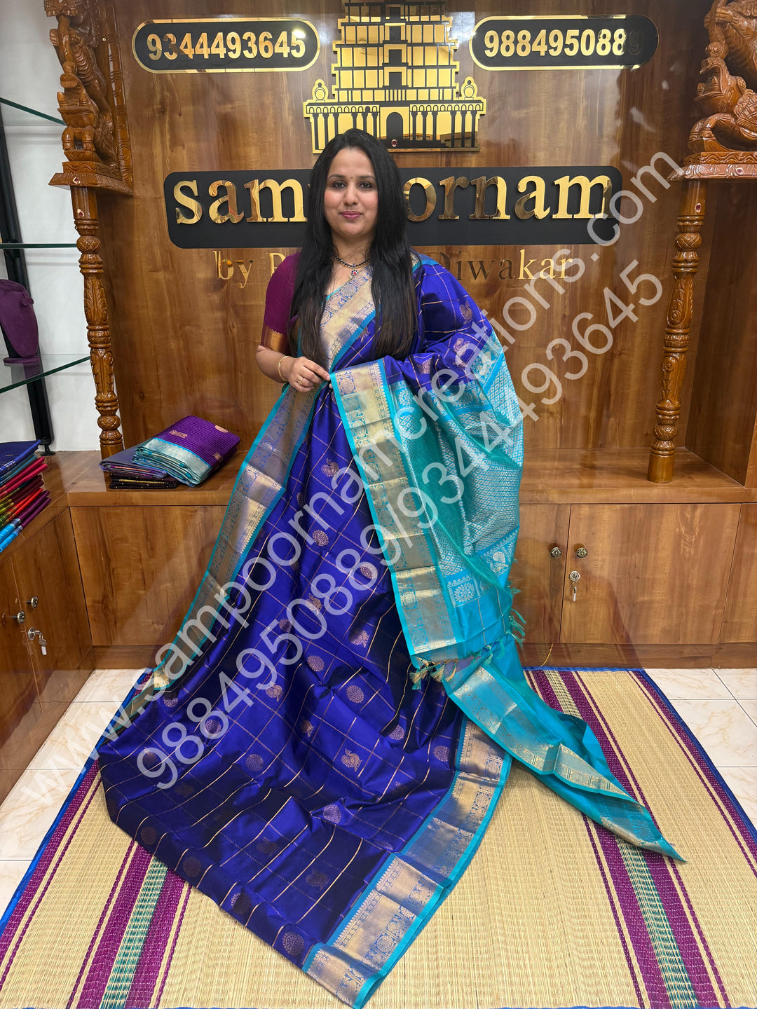 Indigo Blue with Turquoise Blue , Rich Mayil and Chakram butta in the body with Zari Checks , Traditional borders and Rich Pallu Pure Silk Cotton Saree