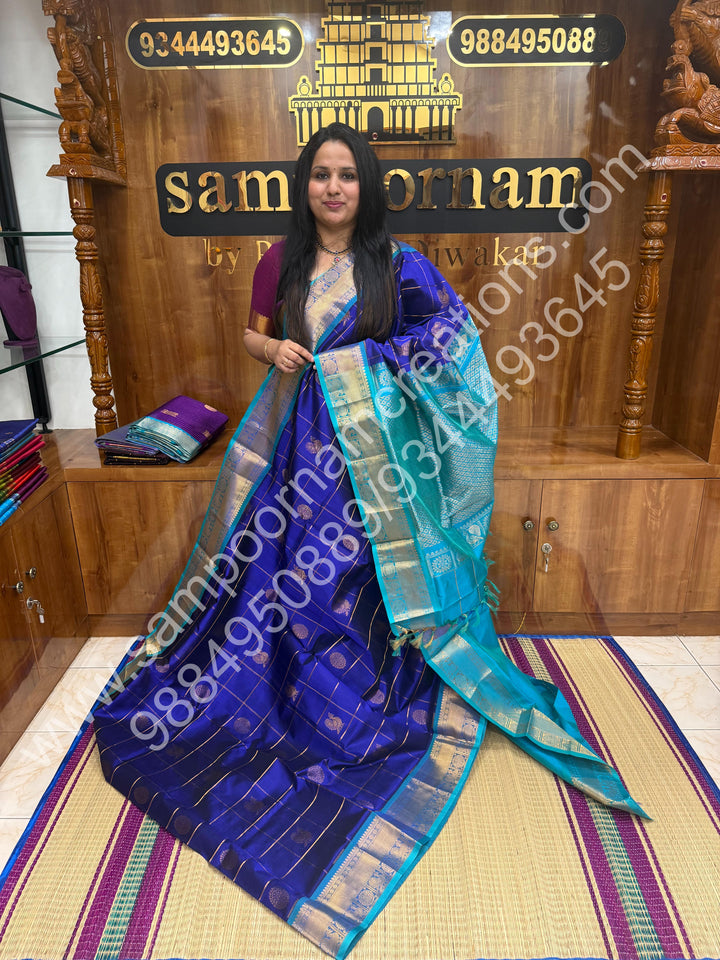 Indigo Blue with Turquoise Blue , Rich Mayil and Chakram butta in the body with Zari Checks , Traditional borders and Rich Pallu Pure Silk Cotton Saree