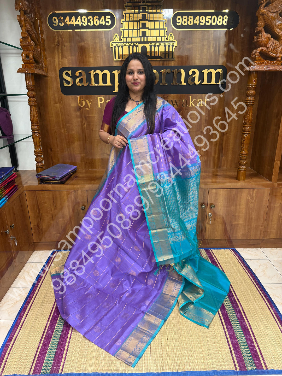 Lavender with Turquoise , Rich Mayil and Chakram butta in the body with Zari Checks , Traditional borders and Rich Pallu Pure Silk Cotton Saree
