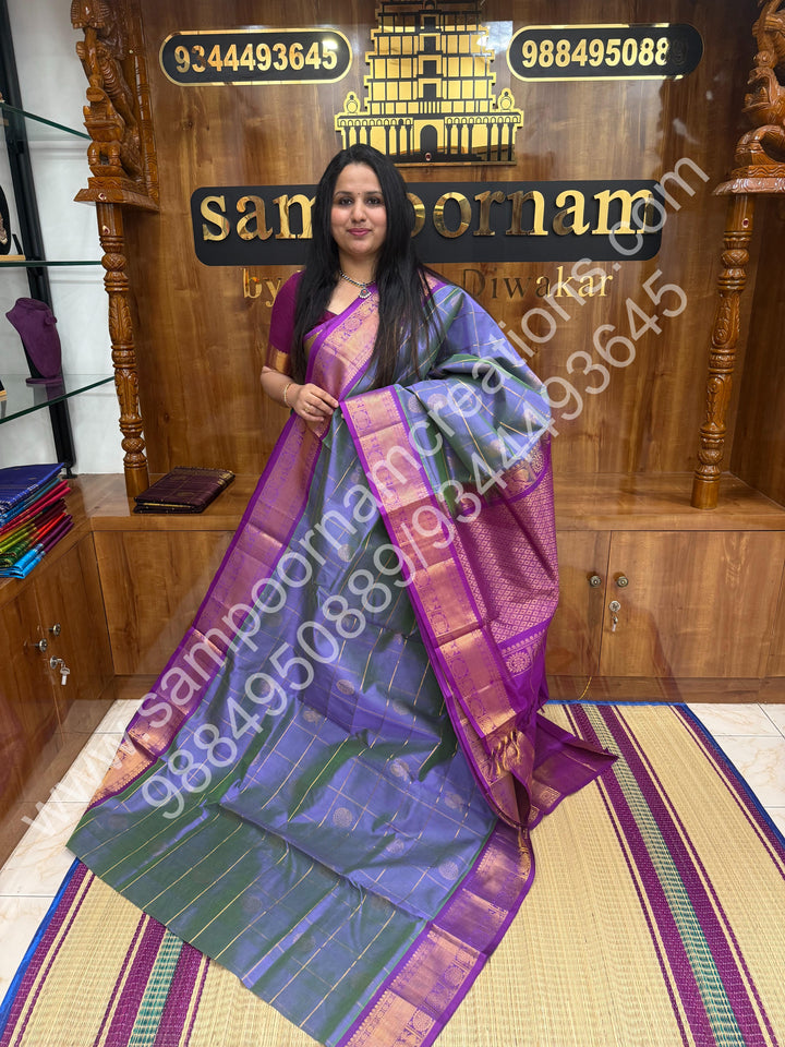 Double Shaded Lilac with Magenta , Rich Mayil and Chakram butta in the body with Zari Checks , Traditional borders and Rich Pallu Pure Silk Cotton Saree