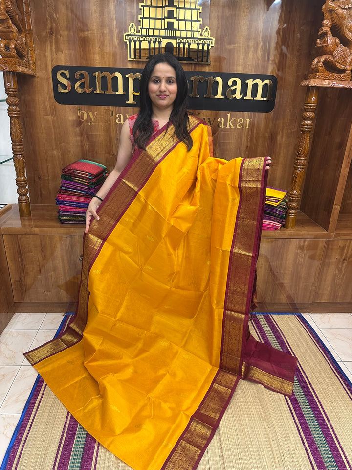 Mambazha Manjal with Red , Rich Mayil Zari Butta in the body and  Traditional borders and Rich Pallu Korvai Silk Cotton Saree
