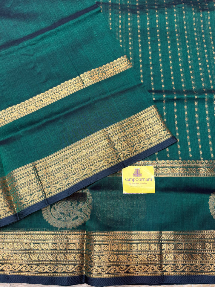 Dark Green ,  Rich Zari butta in the body , Rettapet borders with Bird Zari Motif  and Rich Pallu Silk Cotton Saree