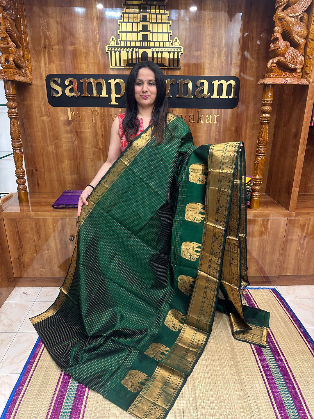 Dark Green , Zari Checks in the body with One side Elephant Motif in the borders , Rich Pallu ,Silk Cotton Saree