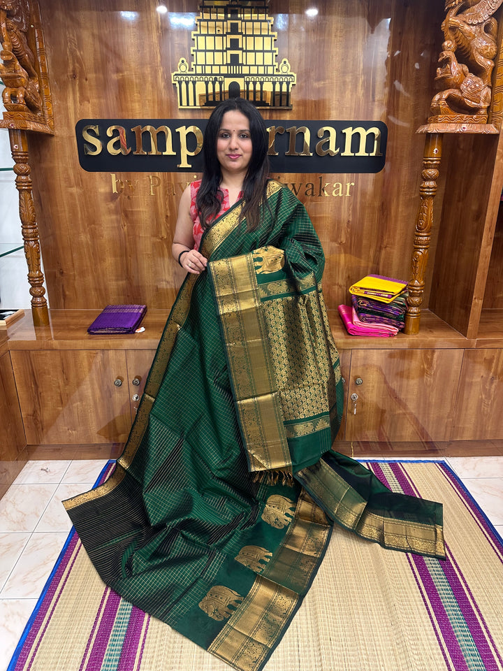 Dark Green , Zari Checks in the body with One side Elephant Motif in the borders , Rich Pallu ,Silk Cotton Saree