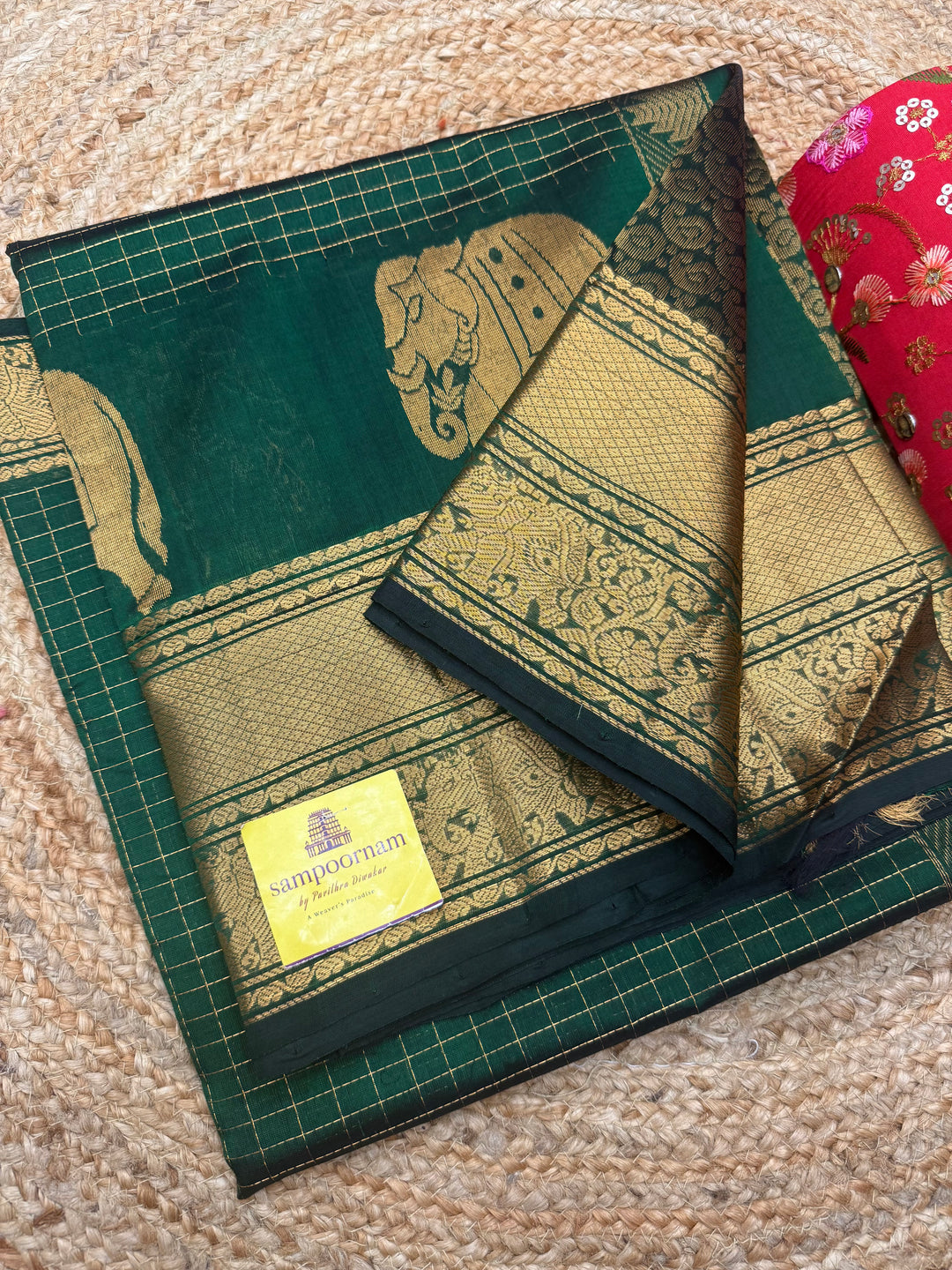 Dark Green , Zari Checks in the body with One side Elephant Motif in the borders , Rich Pallu ,Silk Cotton Saree
