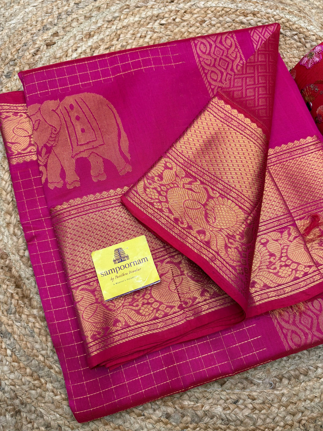 Rani Pink , Zari Checks in the body with One side Elephant Motif in the borders , Rich Pallu ,Silk Cotton Saree