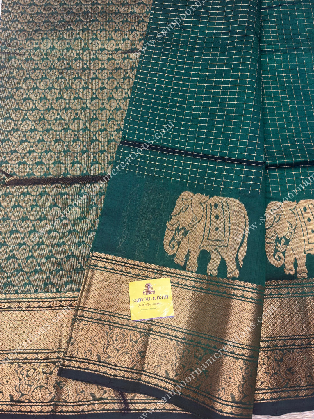 Dark Green , Zari Checks in the body with One side Elephant Motif in the borders , Rich Pallu ,Silk Cotton Saree