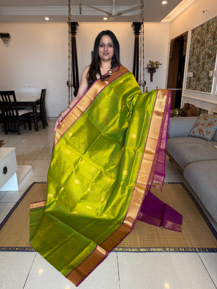 Parrot Green with Purple ,zari kattam in the body with Mayil and Chakram butta ,traditional borders and rich Pallu Silk Cotton Saree
