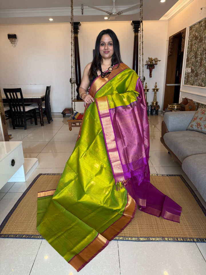 Parrot Green with Purple ,zari kattam in the body with Mayil and Chakram butta ,traditional borders and rich Pallu Silk Cotton Saree