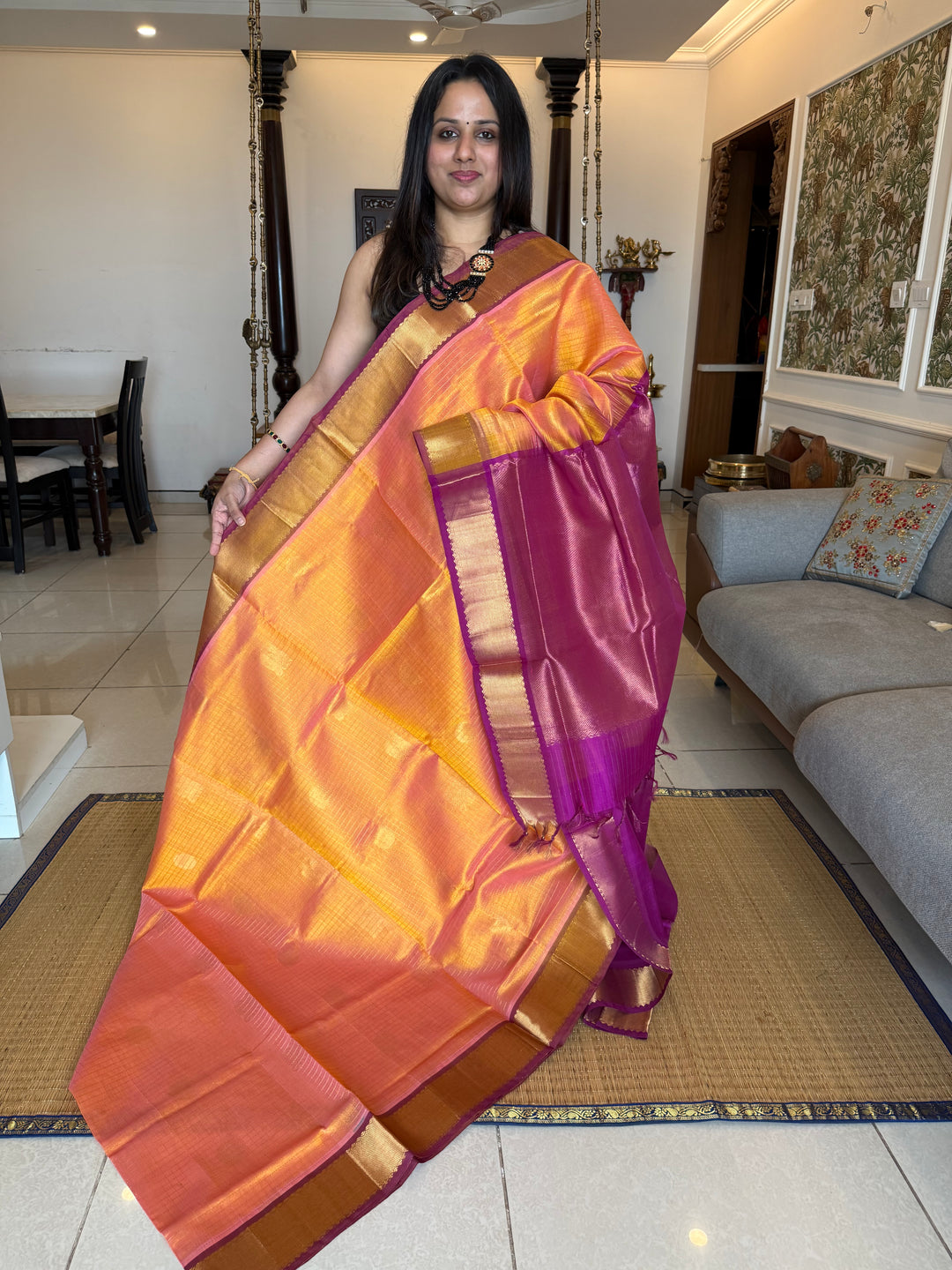 Peachish Orange with Purple colour , zari kattam in the body with Mayil and Chakram butta ,traditional borders and rich Pallu Silk Cotton Saree