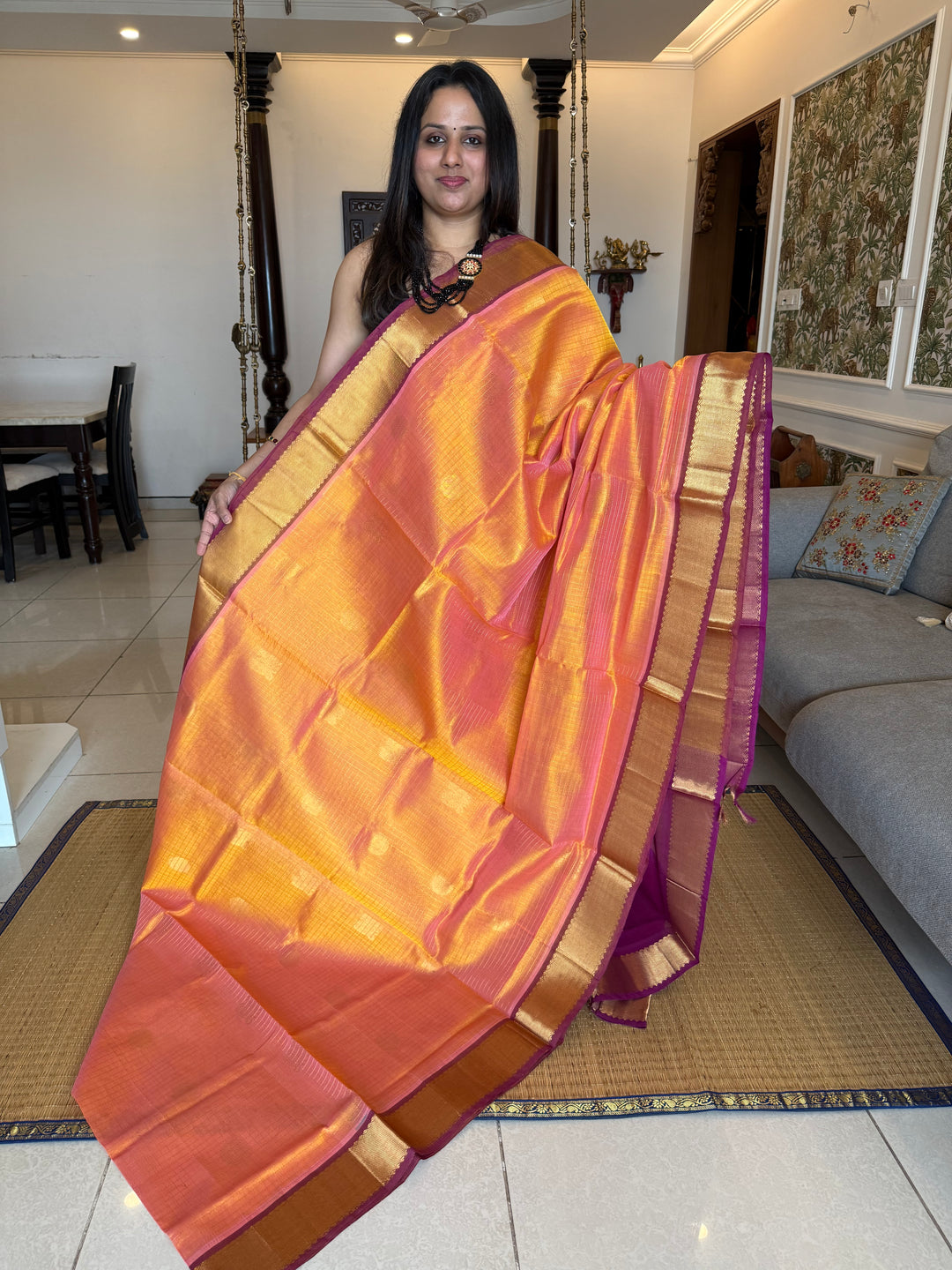 Peachish Orange with Purple colour , zari kattam in the body with Mayil and Chakram butta ,traditional borders and rich Pallu Silk Cotton Saree
