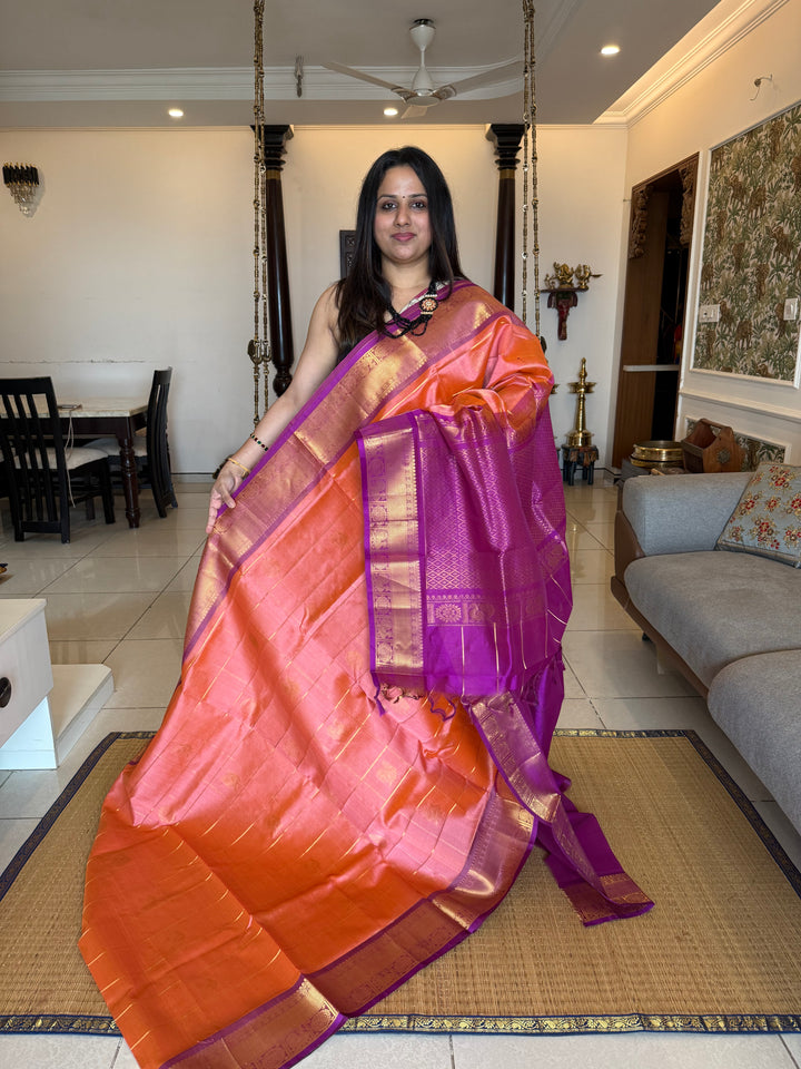 Light Kanakambaram with Purple , zari kattam in the body with Mayil and Chakram butta ,traditional borders and rich Pallu Silk Cotton Saree