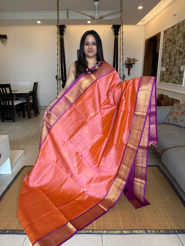 Light Kanakambaram with Purple , zari kattam in the body with Mayil and Chakram butta ,traditional borders and rich Pallu Silk Cotton Saree