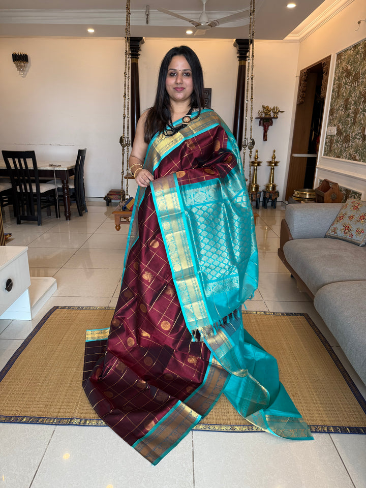 Maroon with Turquoise Blue  , zari kattam in the body with Mayil and Chakram butta ,traditional borders and rich Pallu Silk Cotton Saree