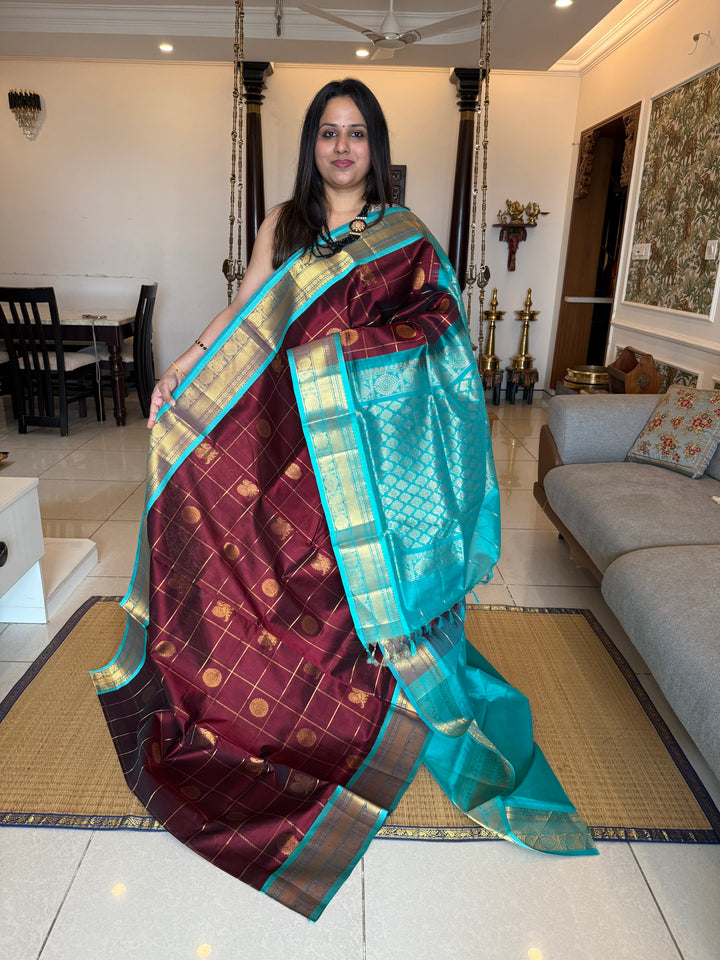 Maroon with Turquoise Blue  , zari kattam in the body with Mayil and Chakram butta ,traditional borders and rich Pallu Silk Cotton Saree