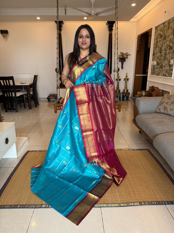 Ramar Blue with Maroon colour , zari kattam in the body with Mayil and Chakram butta ,traditional borders and rich Pallu Silk Cotton Saree