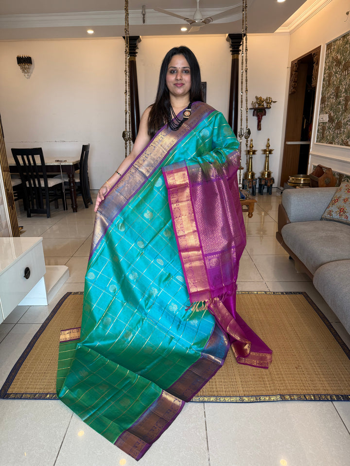 Ramar Blue with Purple  , zari kattam in the body with Mayil and Chakram butta ,traditional borders and rich Pallu Silk Cotton Saree