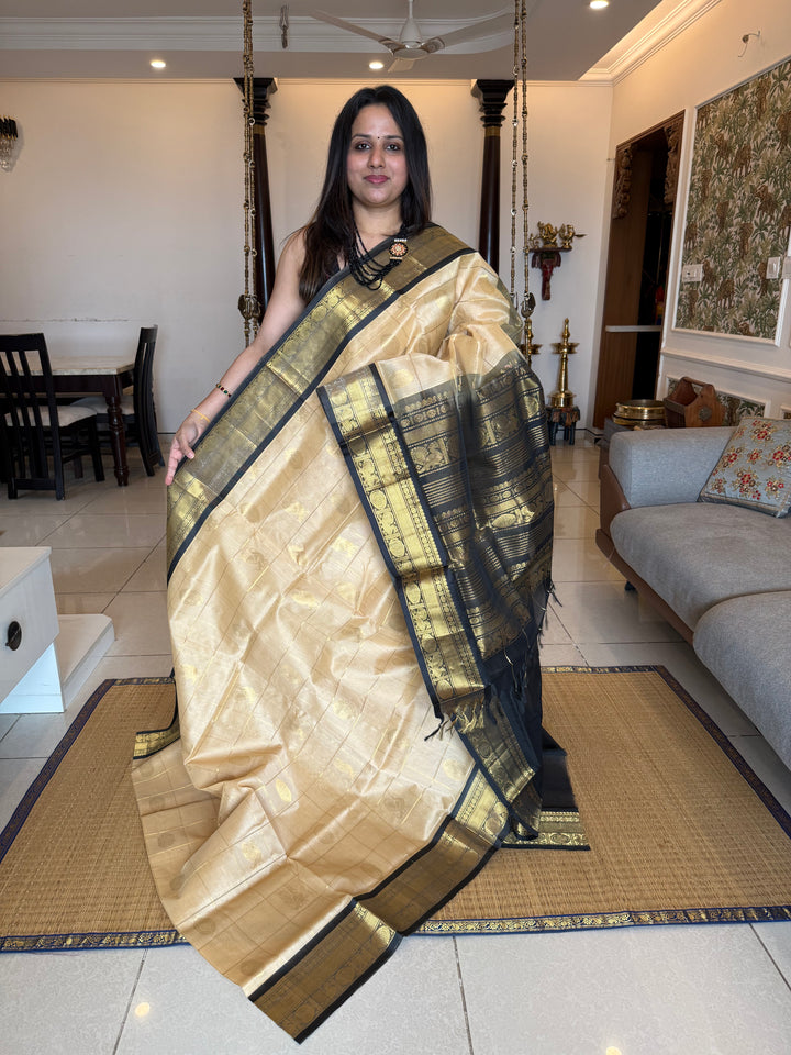 Cream with Black  , zari kattam in the body with Mayil and Chakram butta ,traditional borders and rich Pallu Silk Cotton Saree