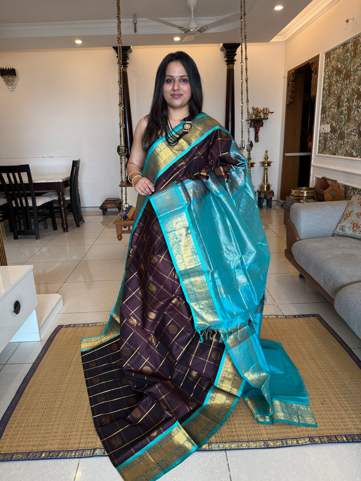 Brown with Turquoise Blue  , zari kattam in the body with Mayil and Chakram butta ,traditional borders and rich Pallu Silk Cotton Saree