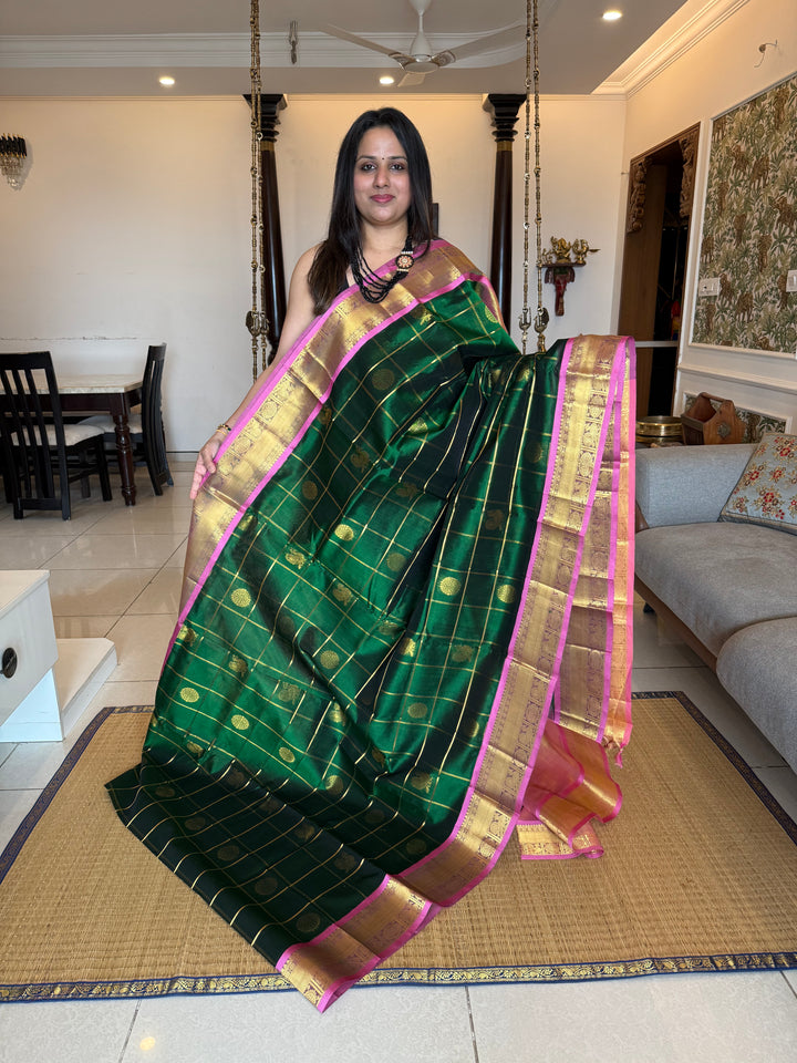 Green with Peachish Pink , Baby Pink Selvedge  , zari kattam in the body with Mayil and Chakram butta ,traditional borders and rich Pallu Silk Cotton Saree