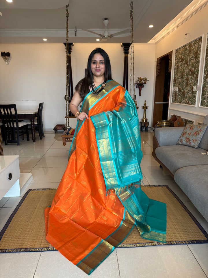 Orange with Turquoise Blue colour , zari kattam in the body with Mayil and Chakram butta ,traditional borders and rich Pallu Silk Cotton Saree