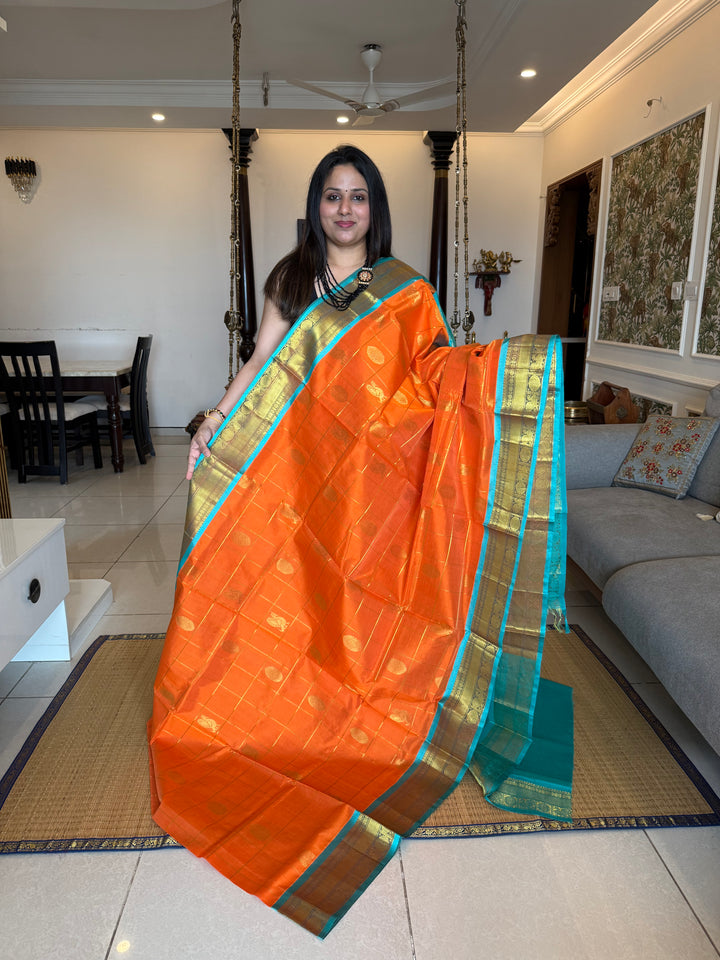 Orange with Turquoise Blue colour , zari kattam in the body with Mayil and Chakram butta ,traditional borders and rich Pallu Silk Cotton Saree