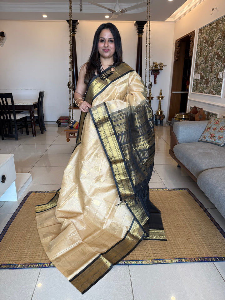 Cream with Black  , zari kattam in the body with Mayil and Chakram butta ,traditional borders and rich Pallu Silk Cotton Saree