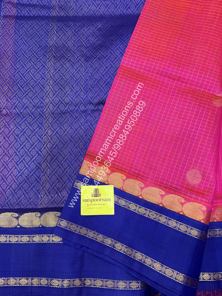 Peachish Pink with Blue , Rich Zari checks in the body , Mayil and Chakram rich butta in the body , Rettapet border and Grand Pallu Korvai Silk Cotton Saree