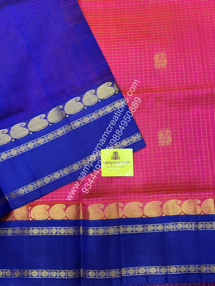 Peachish Pink with Blue , Rich Zari checks in the body , Mayil and Chakram rich butta in the body , Rettapet border and Grand Pallu Korvai Silk Cotton Saree
