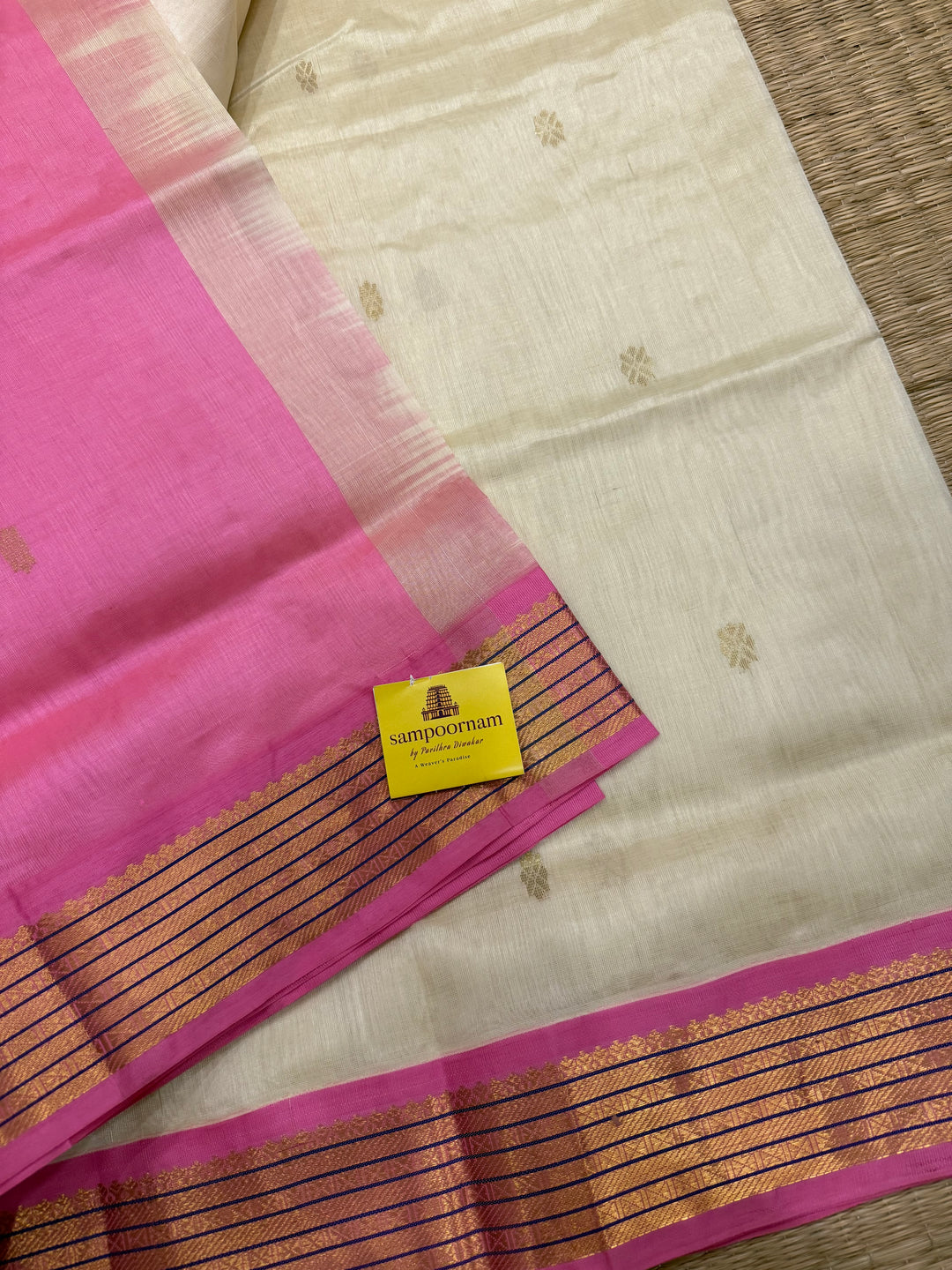 OffWhite with Baby Pink , rich zari butta in the body , traditional borders and rich Pallu Korvai Silk Cotton Saree
