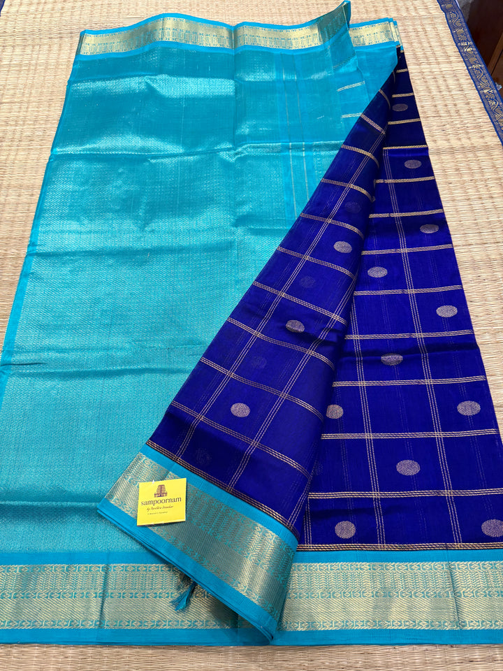 Dark Blue with Light Blue , rich Zari checks in the body with zari butta , ,traditional borders and rich Pallu korvai Silk Cotton Saree