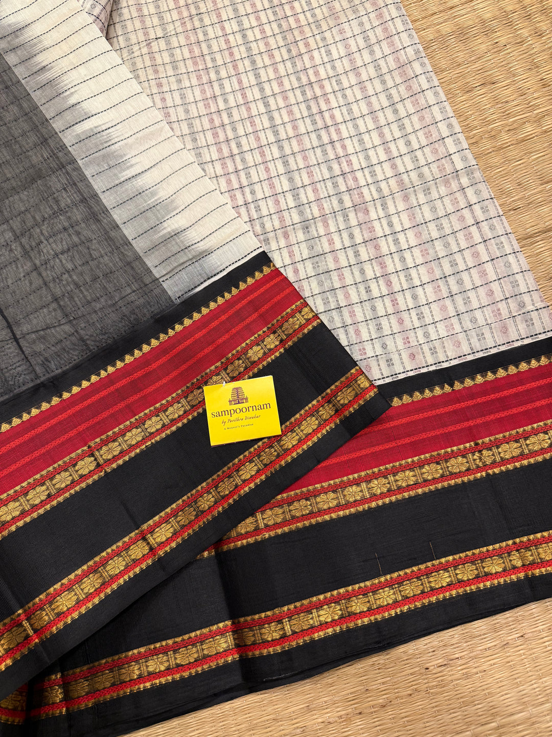 White with Black Lakshadeepam thread pattern in the body with traditional borders and rich Pallu Korvai Silk Cotton Saree