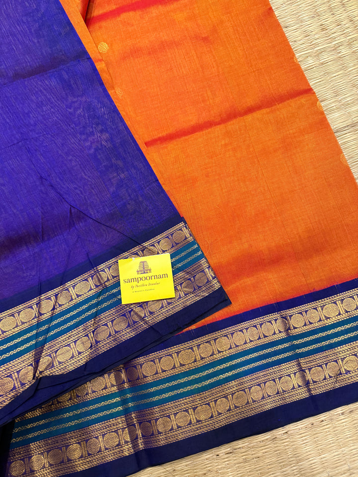 Rust Orange with Dark Blue , rich zari butta in the body , traditional borders and rich Pallu Korvai Silk Cotton Saree