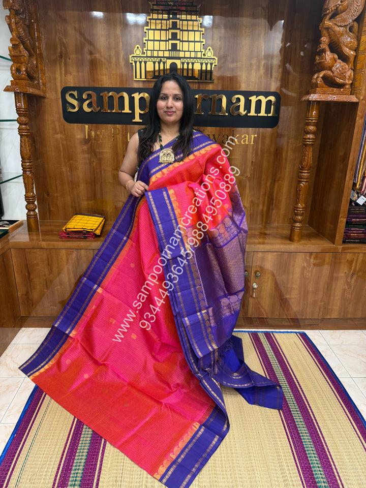 Peachish Pink with Blue , Rich Zari checks in the body , Mayil and Chakram rich butta in the body , Rettapet border and Grand Pallu Korvai Silk Cotton Saree
