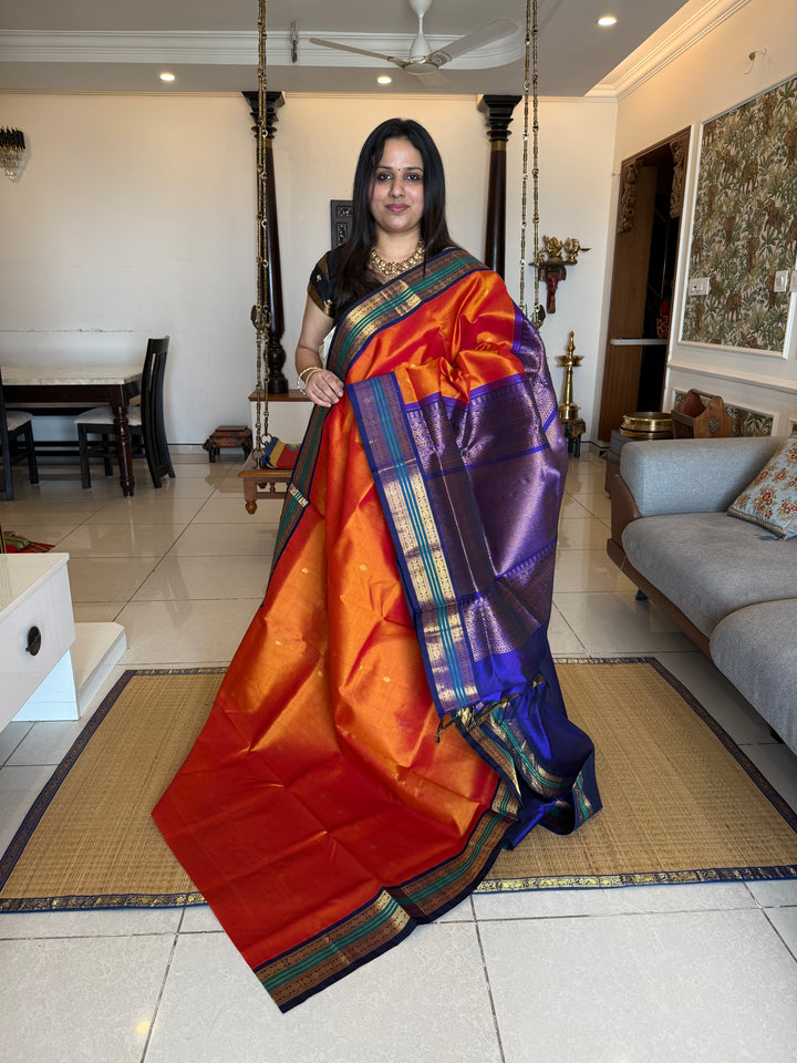 Rust Orange with Dark Blue , rich zari butta in the body , traditional borders and rich Pallu Korvai Silk Cotton Saree