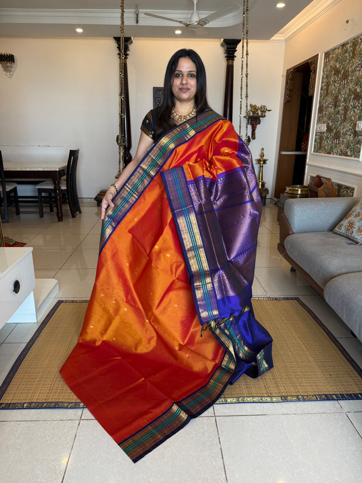 Rust Orange with Dark Blue , rich zari butta in the body , traditional borders and rich Pallu Korvai Silk Cotton Saree