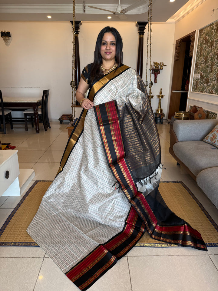 White with Black Lakshadeepam thread pattern in the body with traditional borders and rich Pallu Korvai Silk Cotton Saree