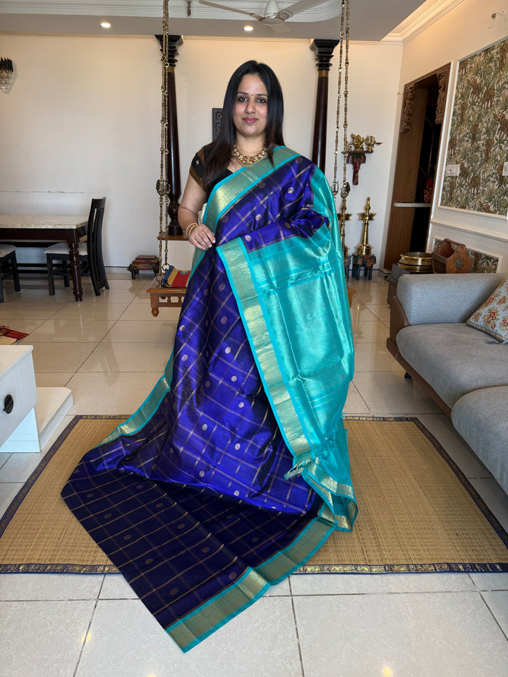 Dark Blue with Light Blue , rich Zari checks in the body with zari butta , ,traditional borders and rich Pallu korvai Silk Cotton Saree